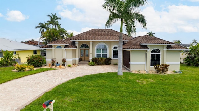 mediterranean / spanish-style house with a front yard