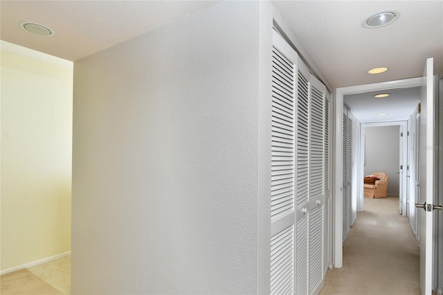 hall featuring a textured ceiling