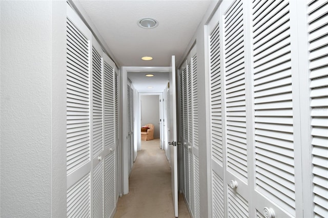 hallway with a textured ceiling