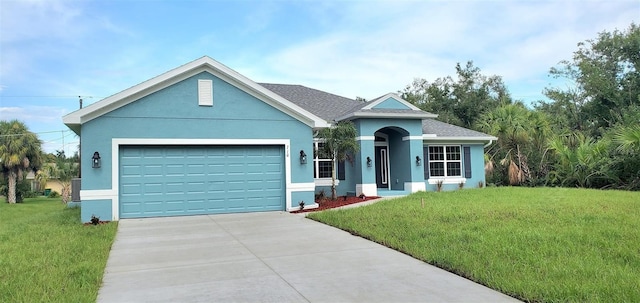 single story home with a front yard and a garage