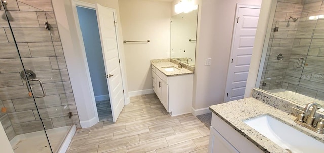 bathroom with a shower with door and vanity