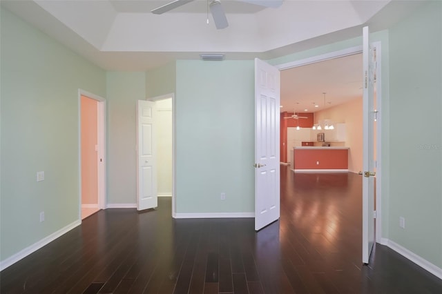 empty room featuring ceiling fan and dark wood-type flooring