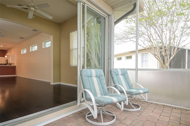 sunroom / solarium featuring ceiling fan