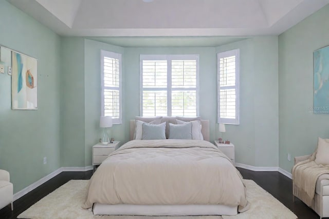 bedroom with dark wood-type flooring