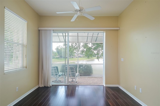 empty room with ceiling fan and dark hardwood / wood-style floors