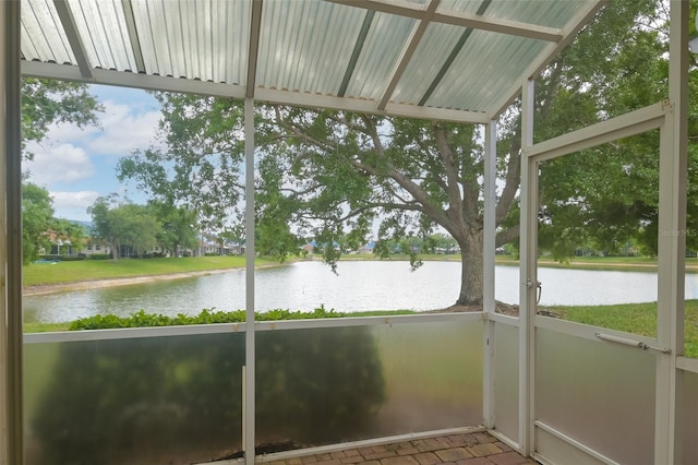 unfurnished sunroom featuring a water view