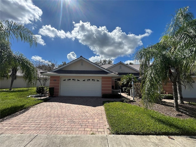 view of front of home featuring a front yard and a garage