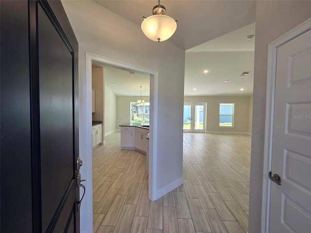 corridor featuring recessed lighting, baseboards, french doors, and wood finish floors