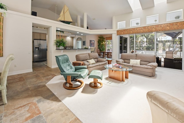 tiled living room with high vaulted ceiling