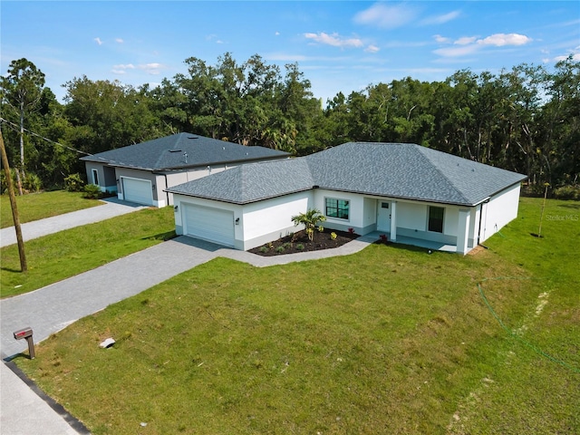 single story home with a garage and a front lawn