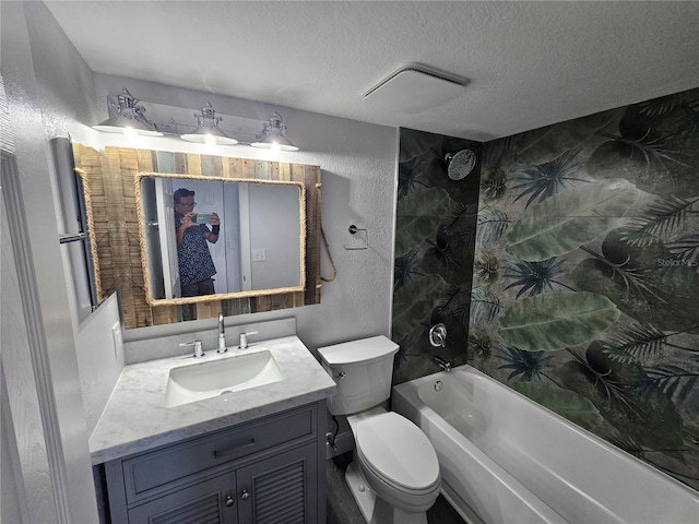 full bathroom with a textured ceiling, toilet, tiled shower / bath combo, and vanity