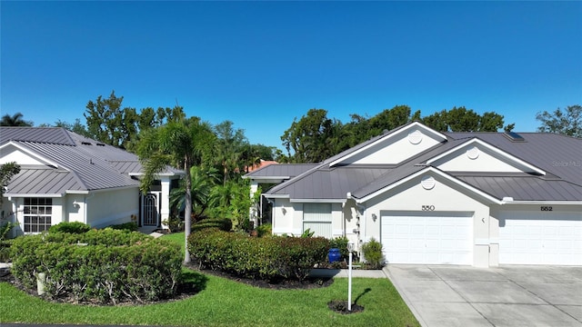 view of front facade featuring a front yard and a garage