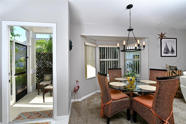 dining room with an inviting chandelier and light carpet