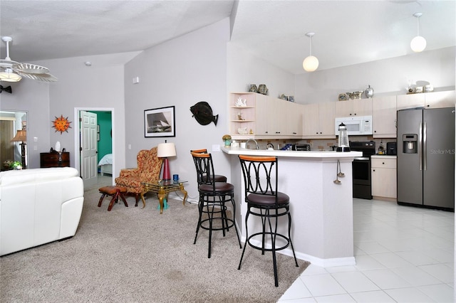 kitchen featuring decorative light fixtures, electric range, ceiling fan, stainless steel fridge with ice dispenser, and light tile floors