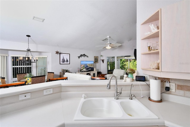 kitchen featuring decorative light fixtures, sink, and ceiling fan with notable chandelier