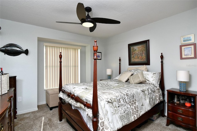 carpeted bedroom featuring a textured ceiling and ceiling fan