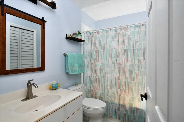 bathroom featuring toilet and vanity