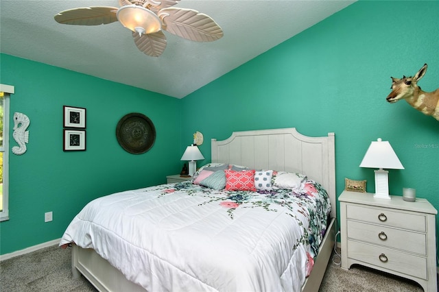 bedroom featuring dark carpet, ceiling fan, and a textured ceiling