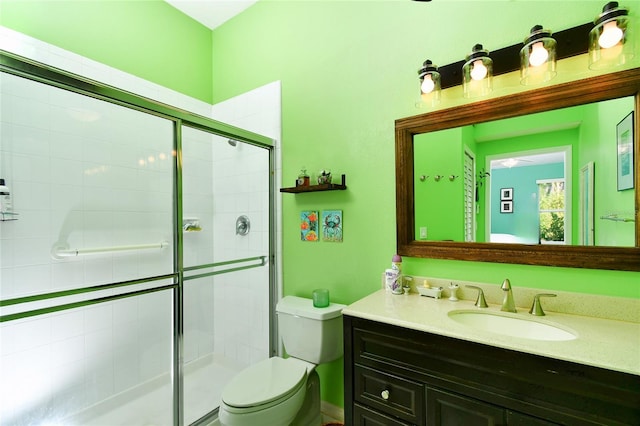 bathroom with toilet, an enclosed shower, and oversized vanity