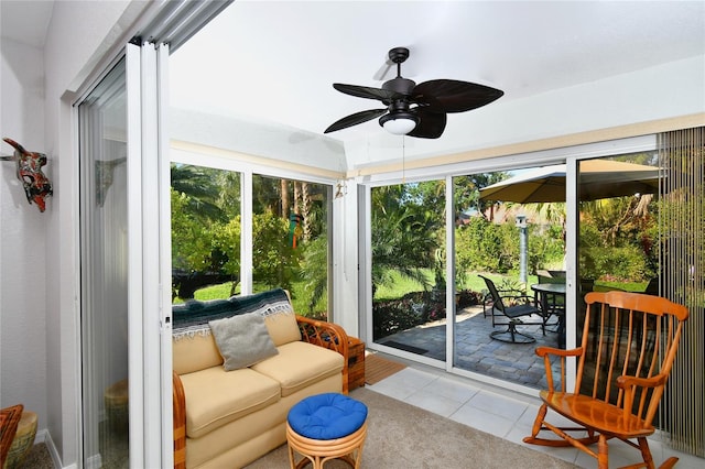 sunroom featuring ceiling fan and a wealth of natural light