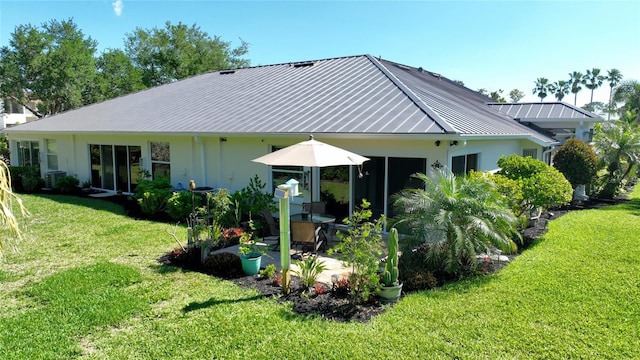 back of property featuring a yard and a patio