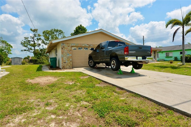 view of side of property with a garage and a lawn