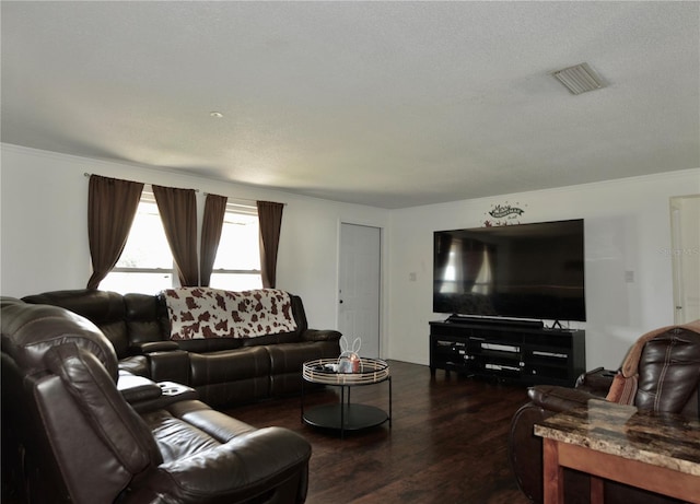 living room featuring dark hardwood / wood-style floors and a textured ceiling