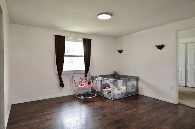 bedroom featuring dark hardwood / wood-style floors and a textured ceiling