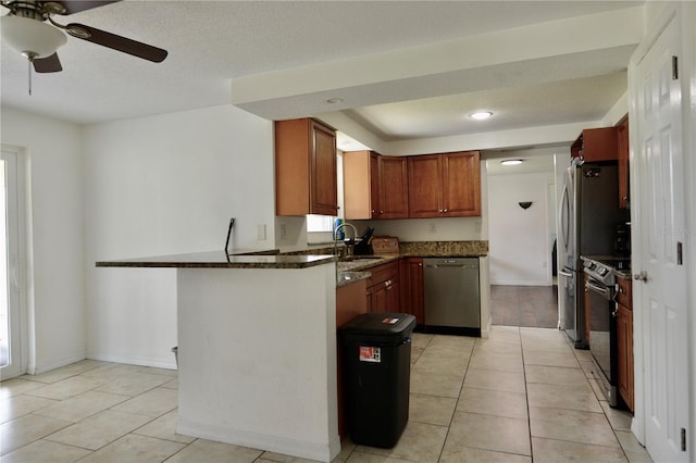 kitchen featuring range with electric cooktop, dishwasher, ceiling fan, and light tile floors