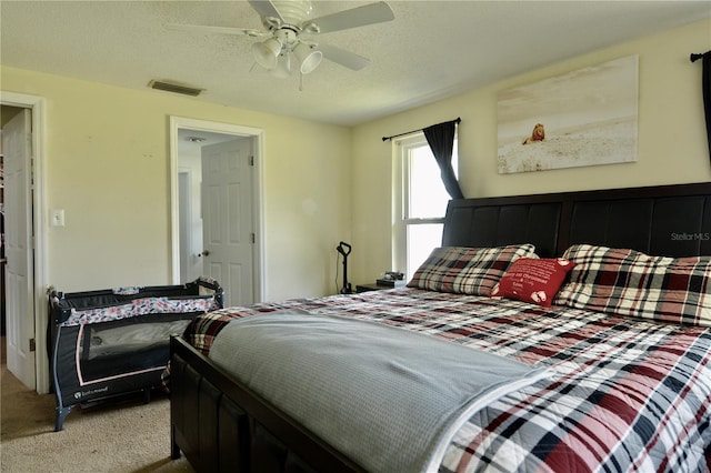 bedroom featuring ceiling fan and light carpet