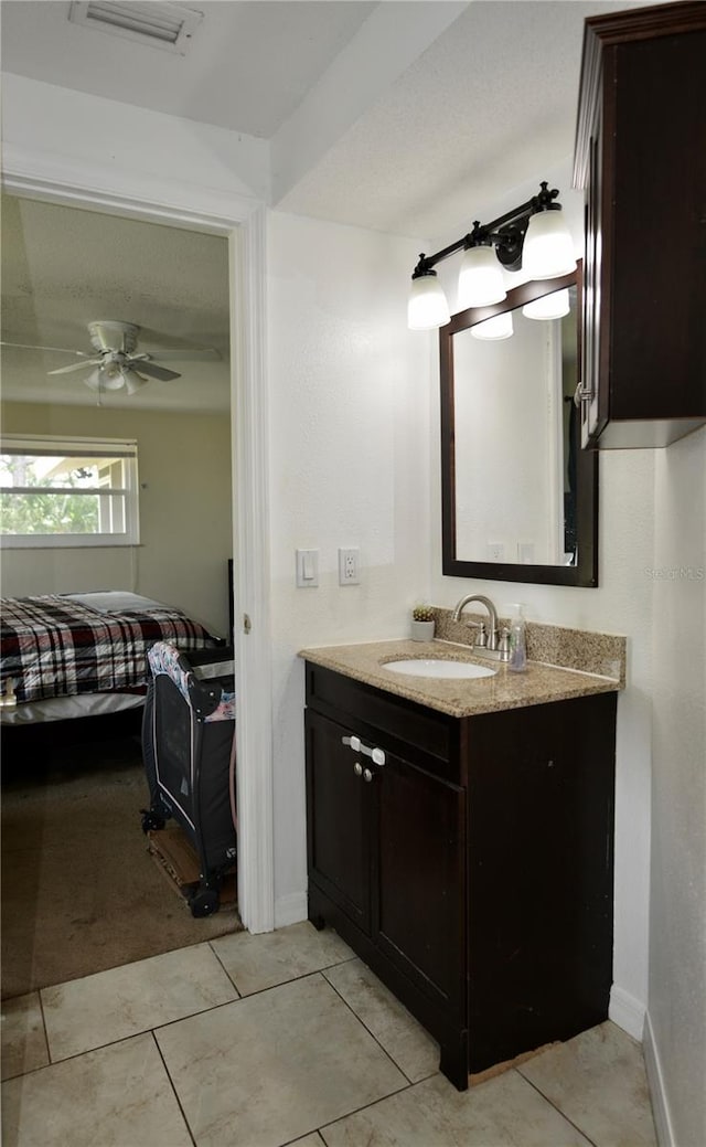 bathroom featuring oversized vanity, ceiling fan, and tile floors