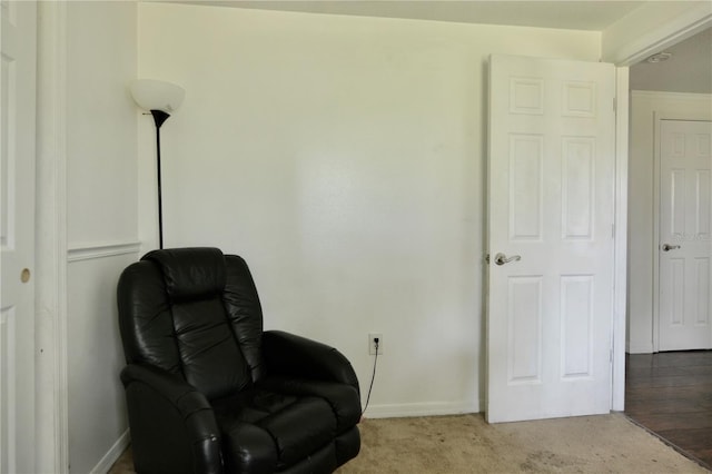 living area featuring light carpet