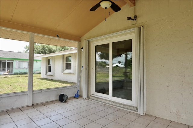 unfurnished sunroom featuring lofted ceiling with beams and ceiling fan