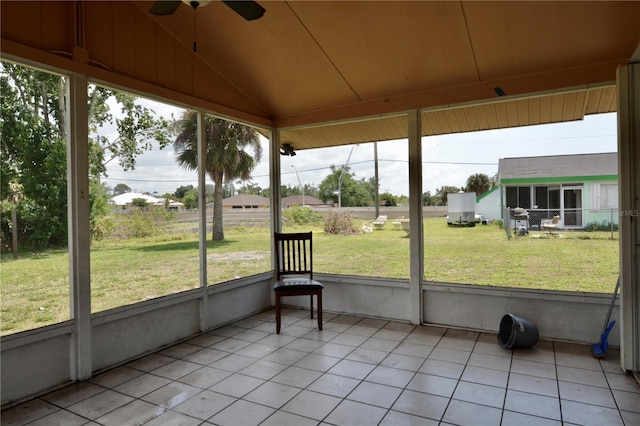 unfurnished sunroom featuring ceiling fan and vaulted ceiling