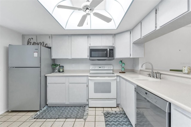 kitchen with ceiling fan, white cabinetry, sink, light tile patterned flooring, and appliances with stainless steel finishes