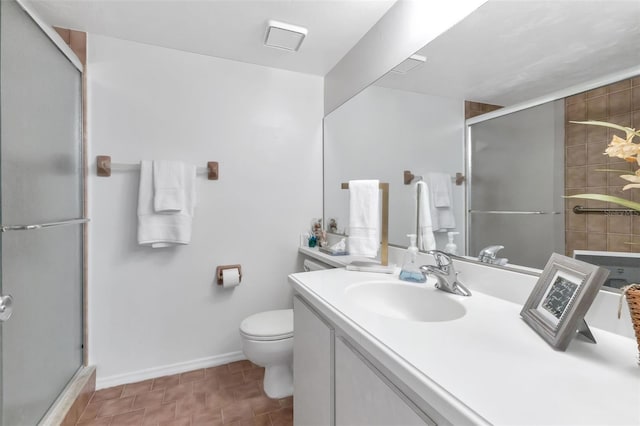 bathroom with tile patterned flooring, vanity, toilet, and a shower with door