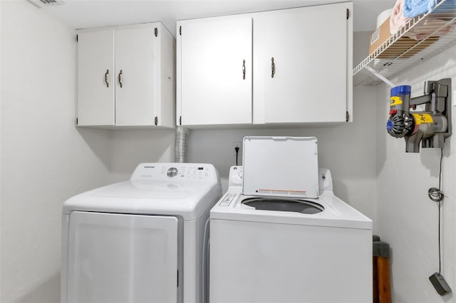 laundry room with cabinets and washer and dryer