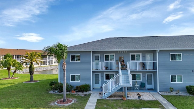 rear view of property with a lawn