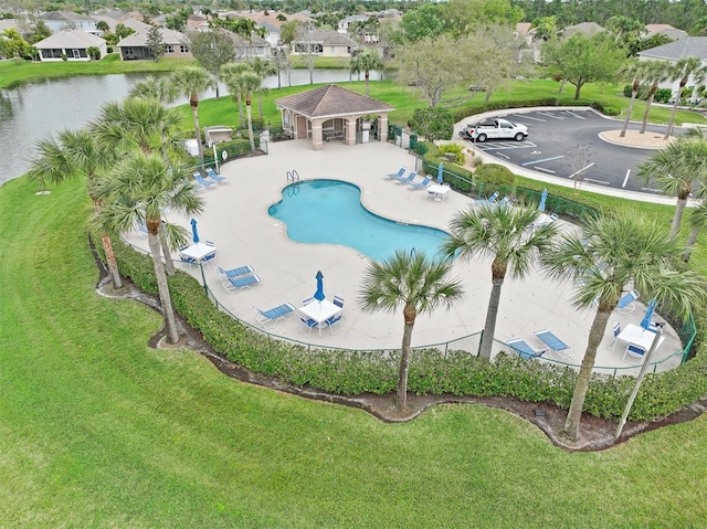 view of swimming pool with a yard, a gazebo, and a water view