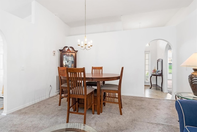 carpeted dining space featuring an inviting chandelier and vaulted ceiling