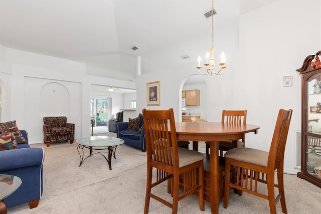 dining space featuring a chandelier and light colored carpet