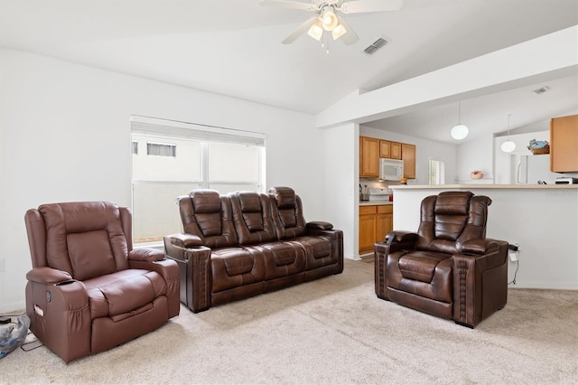 carpeted living room featuring ceiling fan and vaulted ceiling