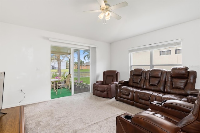 carpeted living room featuring ceiling fan