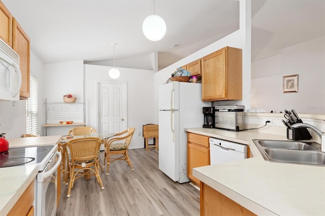 kitchen featuring light hardwood / wood-style floors, vaulted ceiling, white appliances, hanging light fixtures, and sink