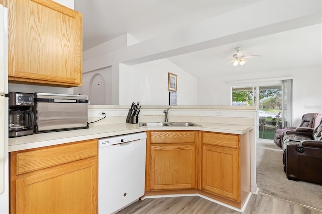 kitchen featuring lofted ceiling, ceiling fan, sink, white dishwasher, and light colored carpet