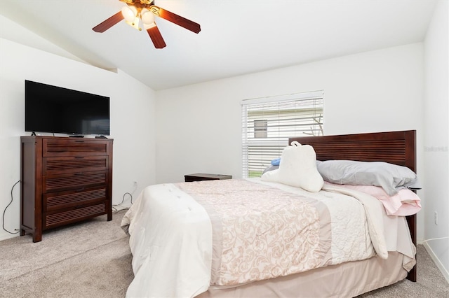 bedroom with ceiling fan, vaulted ceiling, and light colored carpet