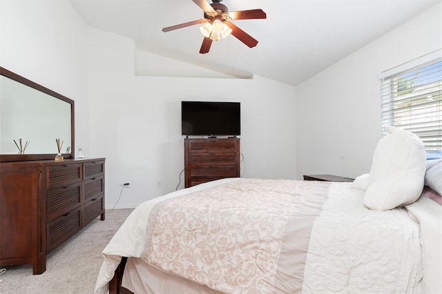 bedroom with light carpet, ceiling fan, and vaulted ceiling