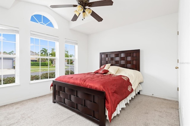 bedroom with light carpet, lofted ceiling, and ceiling fan