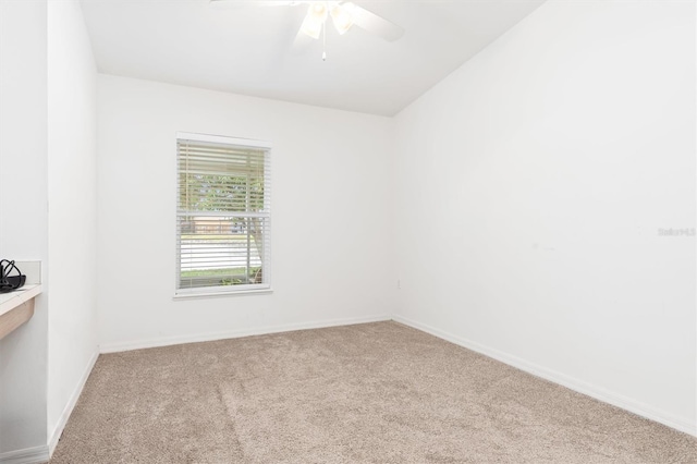 spare room featuring light carpet and ceiling fan