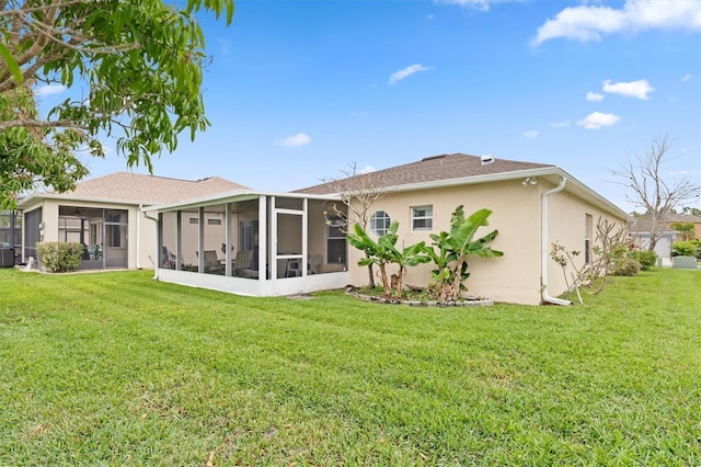 back of property featuring a sunroom and a lawn